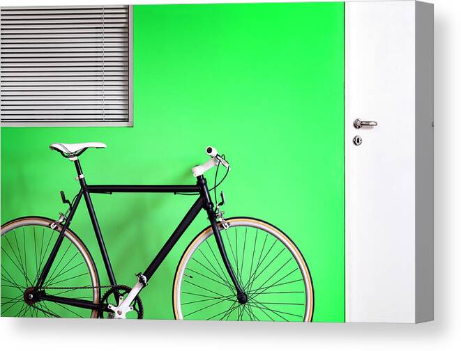 Racing Bicycle Canvas Print featuring the photograph Black Bicycle Green Wall by Carlosalvarez