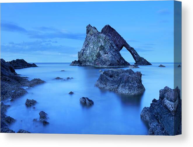 Water's Edge Canvas Print featuring the photograph Bow Fiddle Rock, Natural Arch On Moray by Sara winter