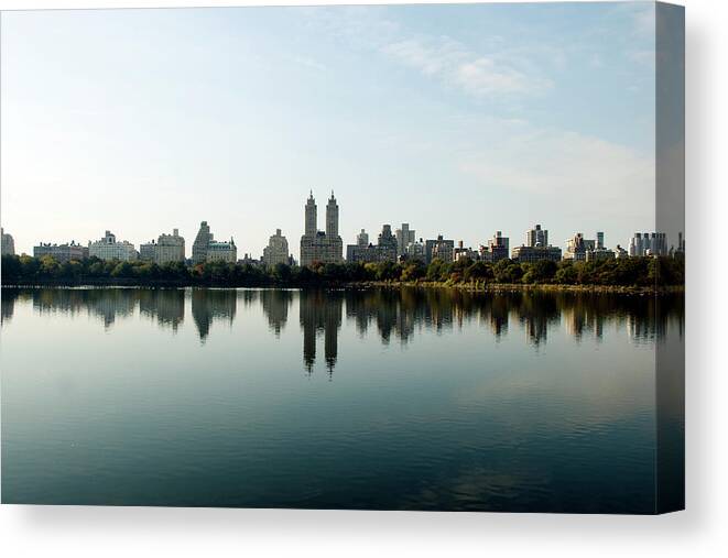 Central Park Canvas Print featuring the photograph Central Park Dakota Reflection In The by Photographs By Vitaliy Piltser