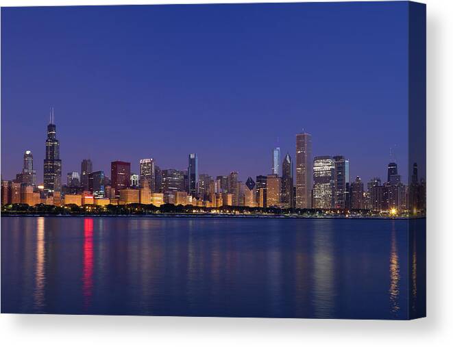 Water's Edge Canvas Print featuring the photograph Chicago Skyline At Dawn by Chrisp0