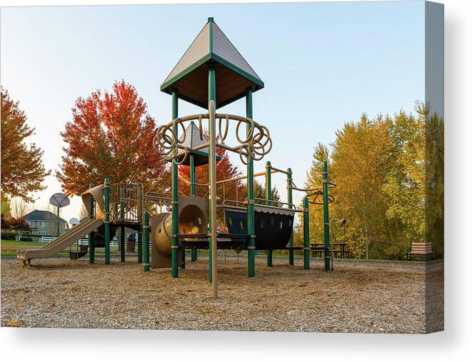 Children Canvas Print featuring the photograph Children Playground in Neighborhood Park in Fall Season by David Gn