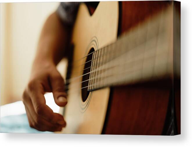Bedroom Canvas Print featuring the photograph Close Up Of Male Hands Playing Classic Guitar Indoors by Cavan Images