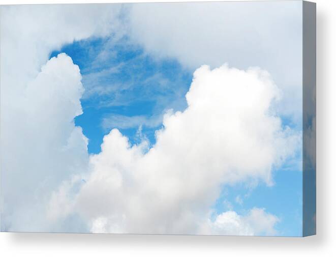Directly Below Canvas Print featuring the photograph Cumulus Clouds And Patch Of Blue by Stuart Mccall