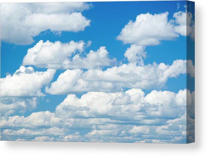 Majestic Canvas Print featuring the photograph Cumulus Clouds In A Clear Blue Sky by Laurance B. Aiuppy