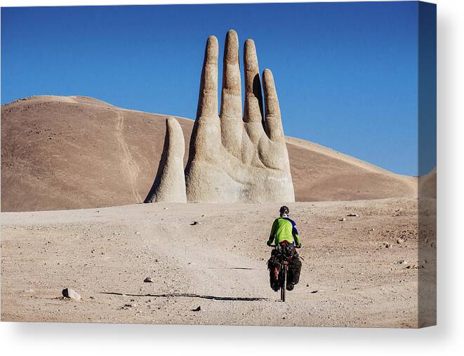 Adventure Canvas Print featuring the photograph Cyclist heading to Hand of the Desert in Atacama Desert, Chile by Kamran Ali