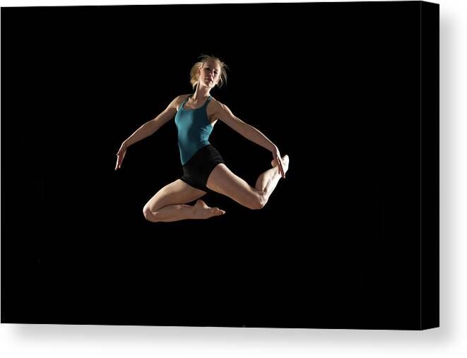 Ballet Dancer Canvas Print featuring the photograph Dancer Jumping On Black Background by Phil Payne Photography
