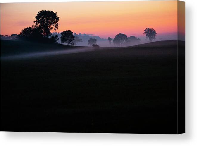 Dawn Canvas Print featuring the photograph Dawn's Early Light Illuminates Morning Ground Fog On Farm Land by Cavan Images