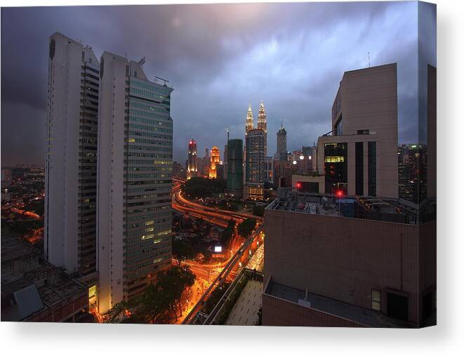 Thunderstorm Canvas Print featuring the photograph Emerging Thunderstorm Over Kuala Lumpur by Shahin Olakara Photography