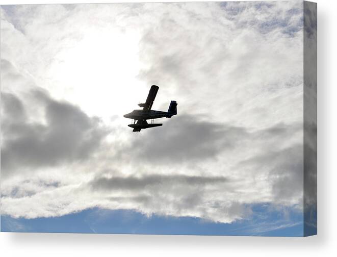 A Seaplane Is Silhouetted Against Clouds Spotlit By The Translucent Glow Of Morning Sun. Canvas Print featuring the photograph Escape by Climate Change VI - Sales