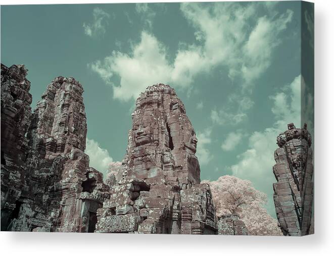 Ancient Canvas Print featuring the photograph Faces of Bayon Temple in infrared by Karen Foley