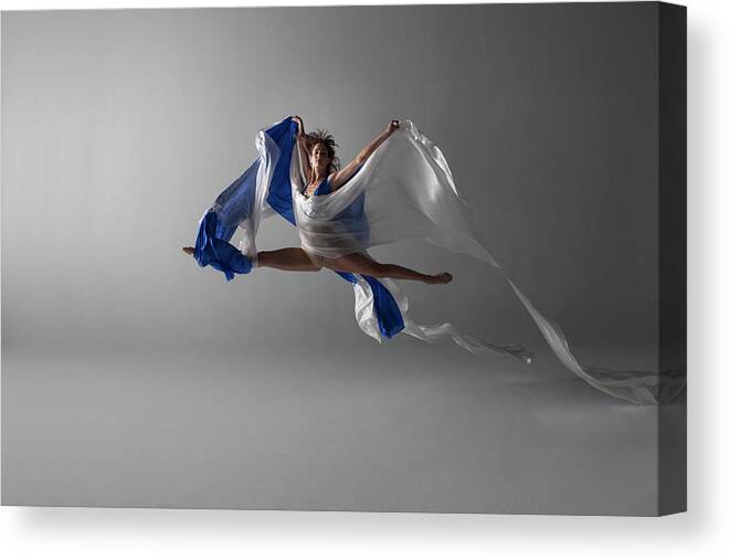 Ballet Dancer Canvas Print featuring the photograph Female Dancer Performing A Grand Jeté by Nisian Hughes