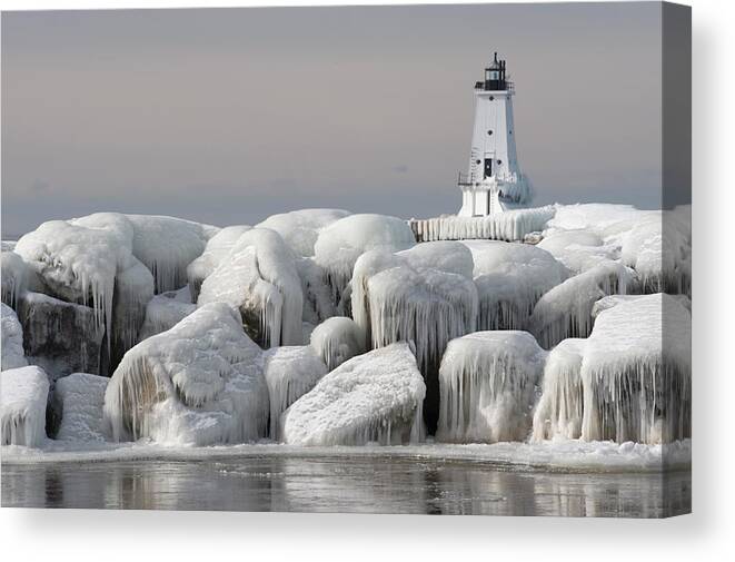 Water's Edge Canvas Print featuring the photograph Great Lakes Lighthouse With Ice Covered by Jskiba