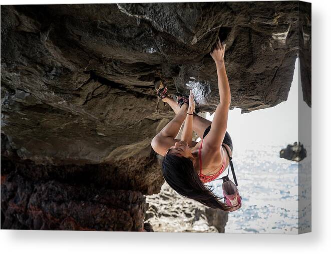 Gutsy Canvas Print featuring the photograph Gutsy Athlete Courageously Hanging From An Enormous Rock At The Arch by Cavan Images