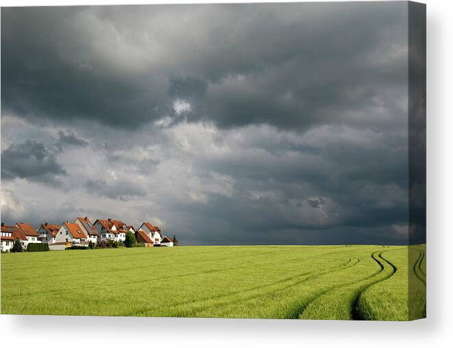 Scenics Canvas Print featuring the photograph Homes And Grain Field With Winding Tire by Thomas Winz