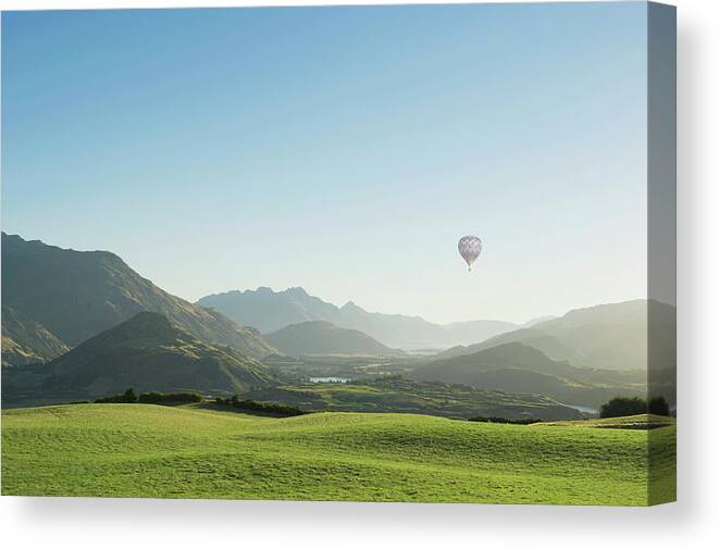 Tranquility Canvas Print featuring the photograph Hot Air Balloon Flying Above Rolling by Jacobs Stock Photography Ltd