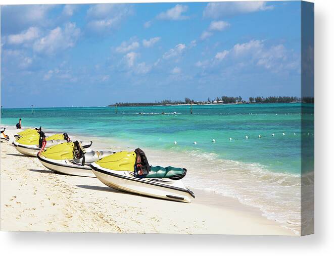 In A Row Canvas Print featuring the photograph Jet Boats On The Beach, Cable Beach by Glowimages