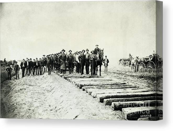 Crowd Of People Canvas Print featuring the photograph Laying Down Railroad Tracks by Bettmann