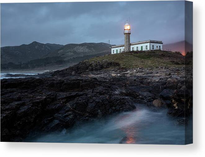 Lighthouse Canvas Print featuring the photograph Lighthouse Just After Sunset With The Light On by Cavan Images