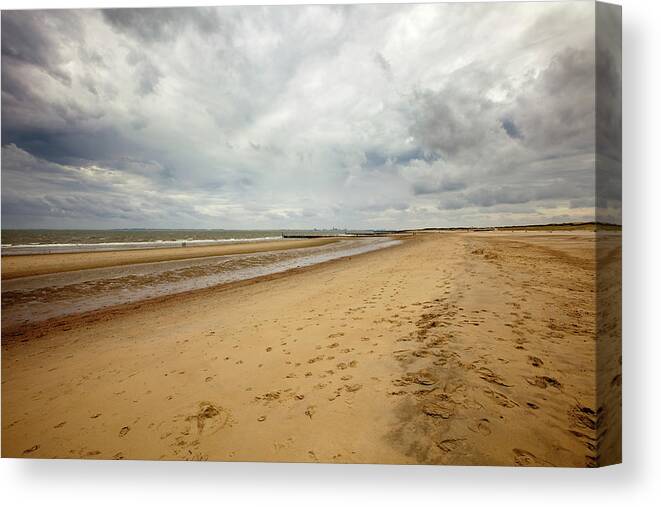 Water's Edge Canvas Print featuring the photograph Loomy Sky Over Beach Wide Angle Shot On by Noctiluxx