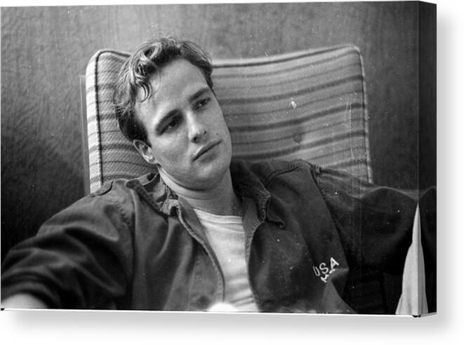 Adults Only Canvas Print featuring the photograph Marlon Brando, sitting on the porch, during the filming of by Ed Clark