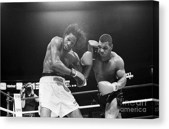 1980-1989 Canvas Print featuring the photograph Mike Tyson Punches Mitch Green by Bettmann