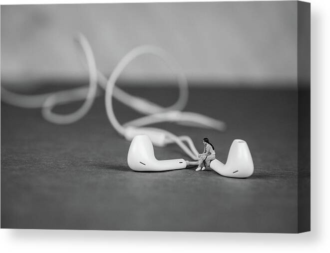 Concept Canvas Print featuring the photograph Miniature Figure listening to Music and Sitting on Earbuds by Tammy Ray
