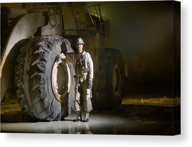 Expertise Canvas Print featuring the photograph Mining Worker Standing Beside Tyre In by Tyler Stableford