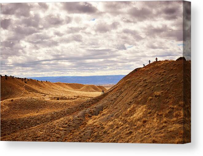 Mountain Biking Canvas Print featuring the photograph Mountain Bikers Ride Down A Steep Section Of Trail In Fruita, Co. by Cavan Images