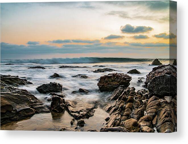 Local Snaps Photography Canvas Print featuring the photograph Painted waves on rocky beach sunset by Local Snaps Photography