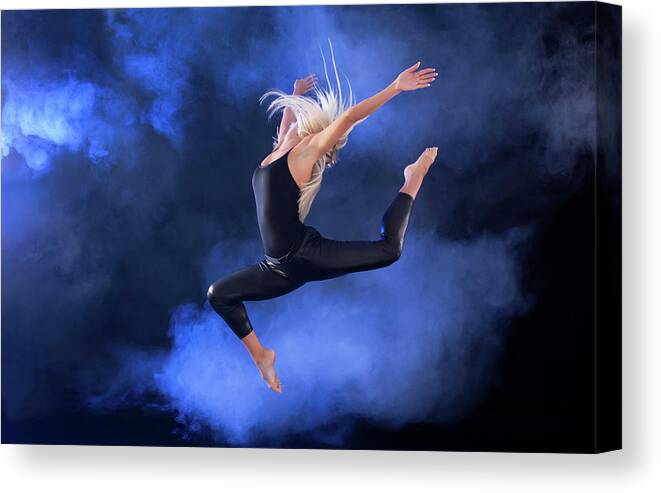 Expertise Canvas Print featuring the photograph Professional Ballerina Jumping Through by Skynesher