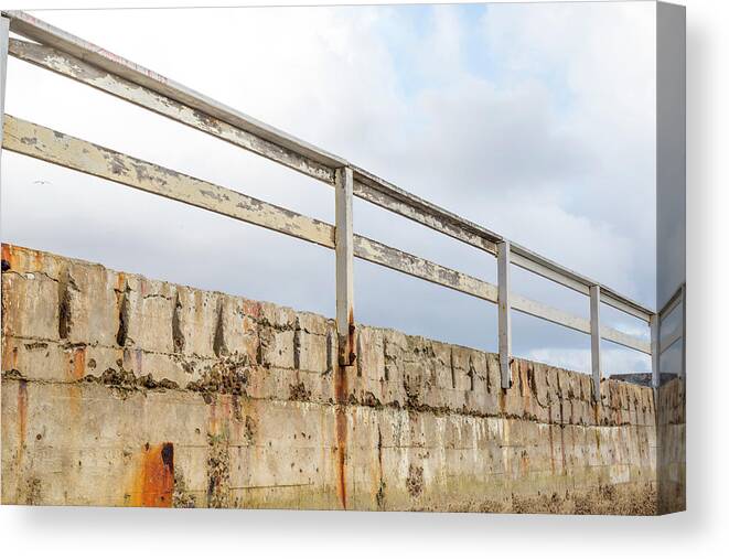Seawall Canvas Print featuring the photograph Seawall Against A Cloudy Sky. by Cavan Images