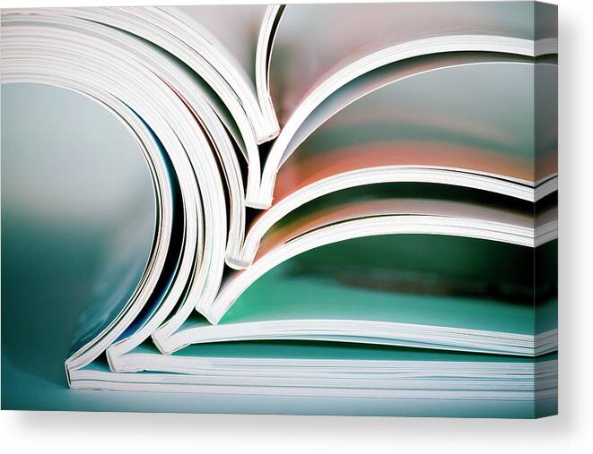 Material Canvas Print featuring the photograph Stack Of Opened Magazines by Mordolff