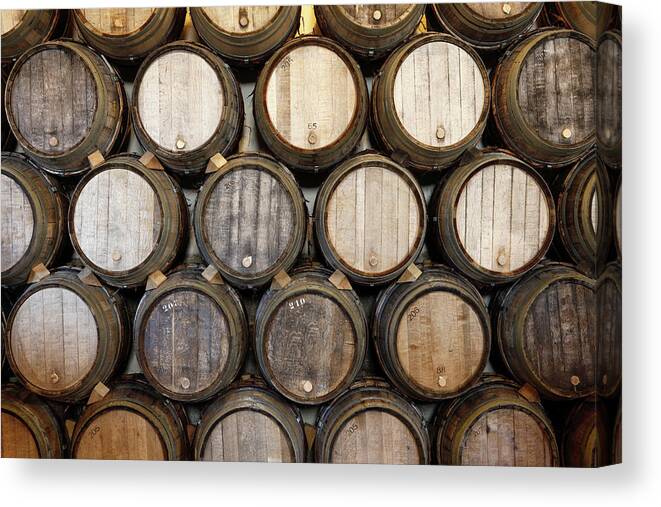 Alcohol Canvas Print featuring the photograph Stacked Oak Barrels In A Winery by Marc Volk