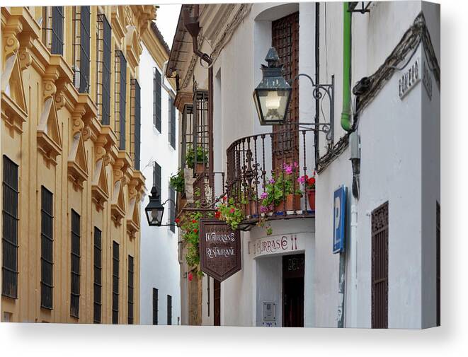 Built Structure Canvas Print featuring the photograph Street And Flowered Balconies At Cordoba by Izzet Keribar