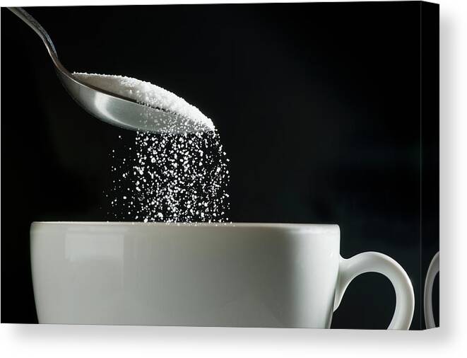 Sugar Canvas Print featuring the photograph Studio Shot Of Sugar Poured Into Coffee by Tetra Images