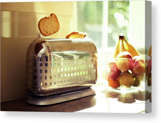 Sunlight Canvas Print featuring the photograph Stylish Chrome Toaster Popping Up Toast by Kelly Sillaste