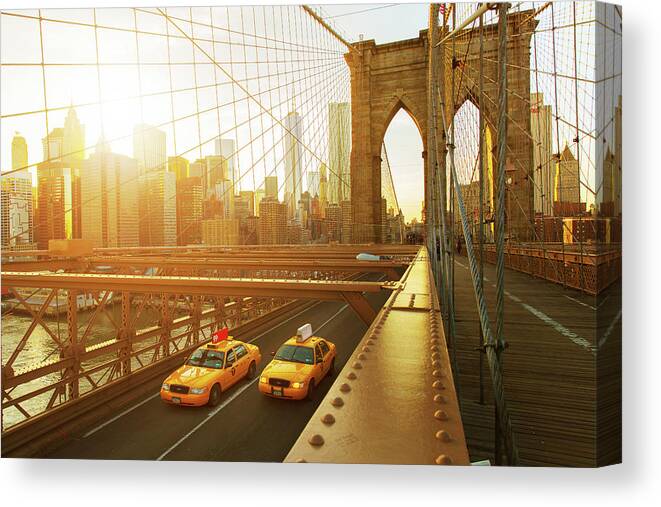 Built Structure Canvas Print featuring the photograph Taxis On The Brooklyn Bridge At Sunset by Tim Robberts