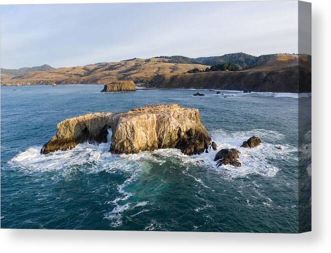 Landscapeaerial Canvas Print featuring the photograph The Pacific Ocean Washes Against A Sea by Ethan Daniels