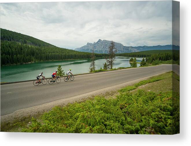 Scenics Canvas Print featuring the photograph Three Bikers Pedal Down Quiet Mountain by Ascent Xmedia