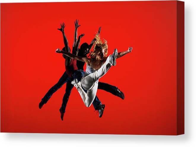 Ballet Dancer Canvas Print featuring the photograph Three Dancers Leaping On Stage by Thomas Barwick