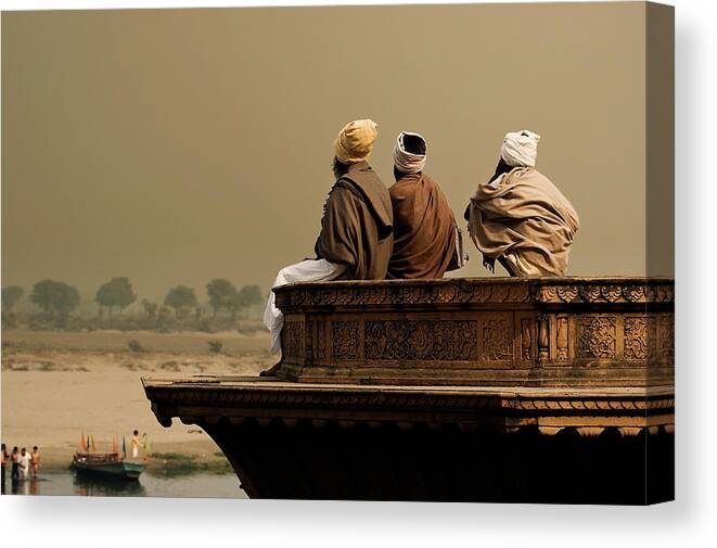 Water's Edge Canvas Print featuring the photograph Three Sadhus Meditating By The Yamuna by Globalstock