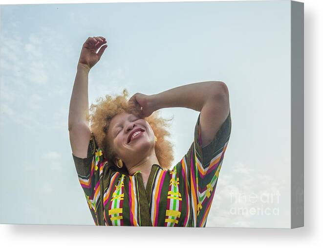 Diversity Canvas Print featuring the photograph Woman Smiling Against Sky by Yagazie Emezi