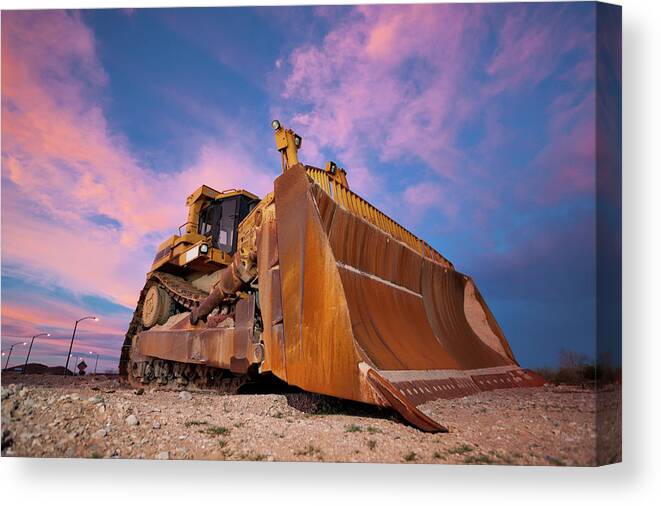 Toughness Canvas Print featuring the photograph Yellow Bulldozer Working At Sunset by Wesvandinter