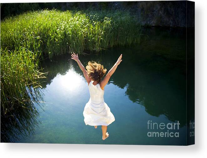 Bride Canvas Print featuring the photograph Young Woman In White Dress Jumping by Luna Vandoorne
