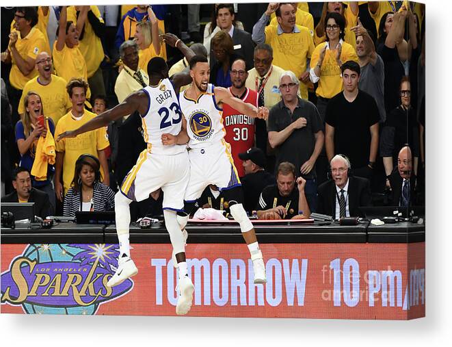 Stephen Curry Canvas Print featuring the photograph Draymond Green and Stephen Curry #1 by Garrett Ellwood