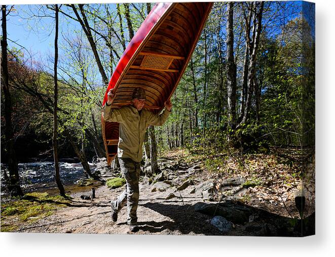 Camping Canvas Print featuring the photograph Man camping at the riverbank with a canoe #1 by Max shen