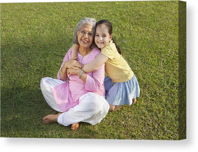 Grass Canvas Print featuring the photograph Portrait of grandmother and granddaughter smiling #1 by Ravi Ranjan