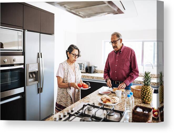 Breakfast Canvas Print featuring the photograph Senior married couple eating healthy food for breakfast. #1 by Drazen_