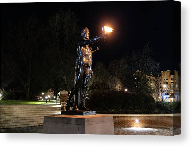 University Of Tennessee At Night Canvas Print featuring the photograph Torchbearer statue at the University of Tennessee at night by Eldon McGraw