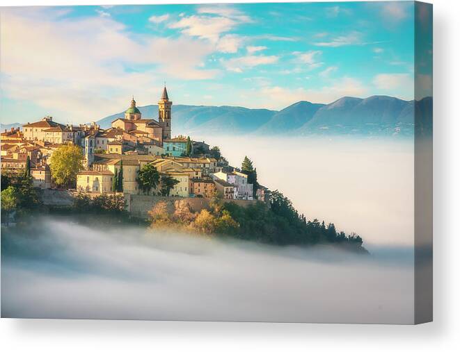 Trevi Canvas Print featuring the photograph Trevi picturesque village in a foggy morning. Perugia, Umbria, I by Stefano Orazzini
